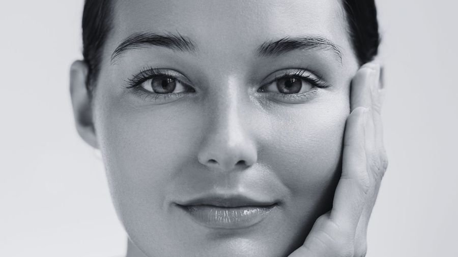 Close portrait of a woman touching her cheek
